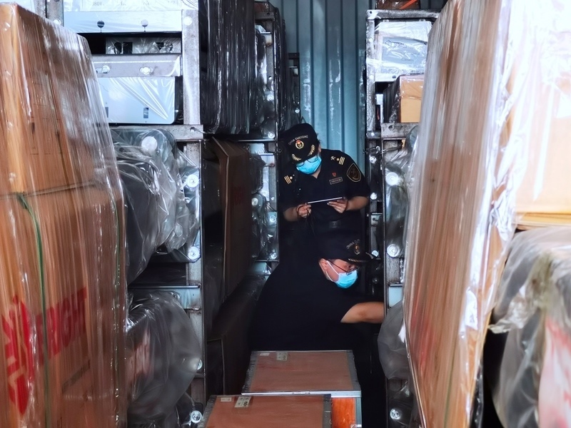 關(guān)員利用工業(yè)內(nèi)窺鏡在集裝箱內(nèi)進行查驗。人民網(wǎng)記者 栗翹楚攝