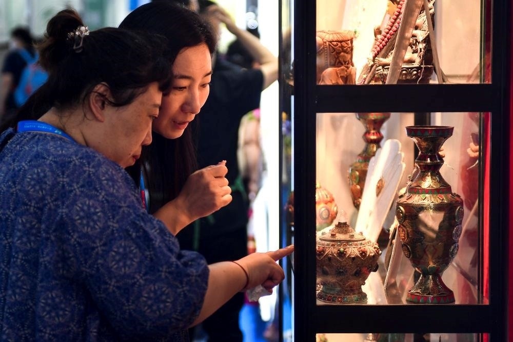 △2023年8月24日，參觀者在第十四屆中國—東北亞博覽會現(xiàn)場選購尼泊爾特色商品。