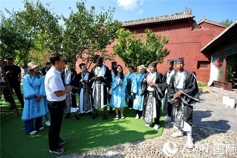 圖為選手們聽導游講解。人民網(wǎng) 盧鵬宇攝