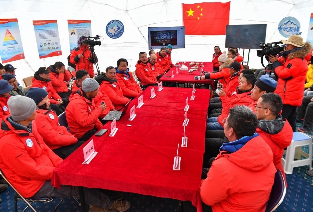海拔4950米的卓奧友峰科考大本營，科考隊員趙華標（手拿麥克風看電腦者）在宣讀剛剛接收到的頂峰氣象觀測數(shù)據(jù)，這標志著峰頂自動氣象站架設成功，成功傳回觀測數(shù)據(jù)（10月1日攝）。新華社記者晉美多吉 攝