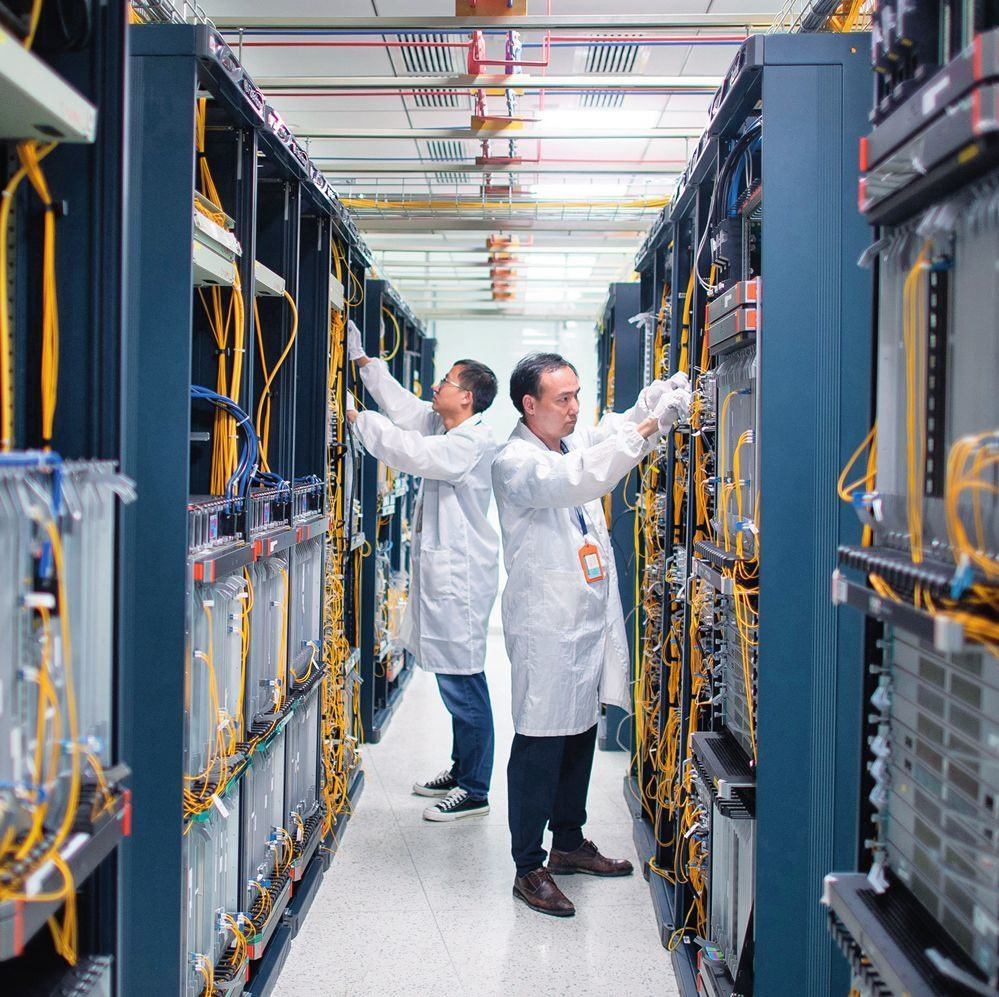 在位于武漢中國光谷的光電器件研發(fā)制造商——武漢光迅科技股份有限公司生產(chǎn)車間內(nèi)，技術(shù)人員在光模塊生產(chǎn)線作業(yè)（2023年4月11日攝）。程敏攝/本刊