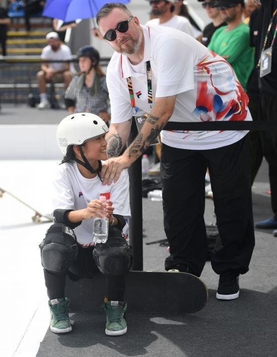 6月20日，鄭好好（左）在比賽間隙與教練互動，她在預(yù)賽中最佳成績?yōu)?2.60分。當(dāng)日，巴黎奧運(yùn)會資格系列賽布達(dá)佩斯站滑板女子碗池預(yù)賽在布達(dá)佩斯舉行。新華社記者 賀燦鈴 攝