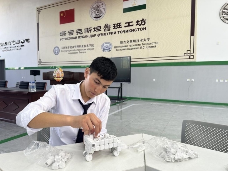 在塔吉克斯坦魯班工坊內(nèi)，學(xué)員正在操作能力源創(chuàng)新套件。本報(bào)記者 屈佩 攝