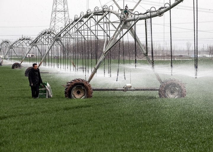 2024年3月18日，在河南省焦作市博愛縣孝敬鎮(zhèn)東原莊村瑞輝家庭農(nóng)場，村民使用全自動(dòng)指針式噴灌機(jī)進(jìn)行澆灌作業(yè)。新華社發(fā)（程全攝）