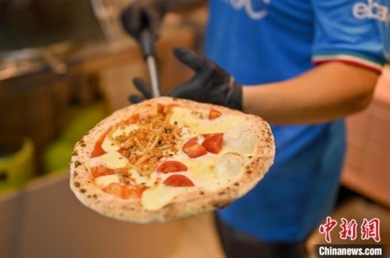 近日，韋榮耀展示他制作的“老友味”披薩。 俞靖 攝